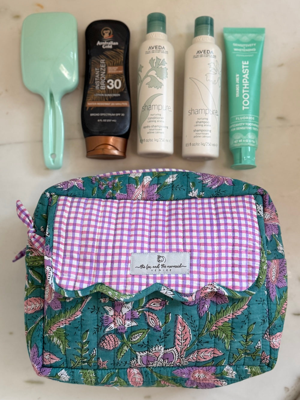 block printed cosmetics bag with 4 large bottles