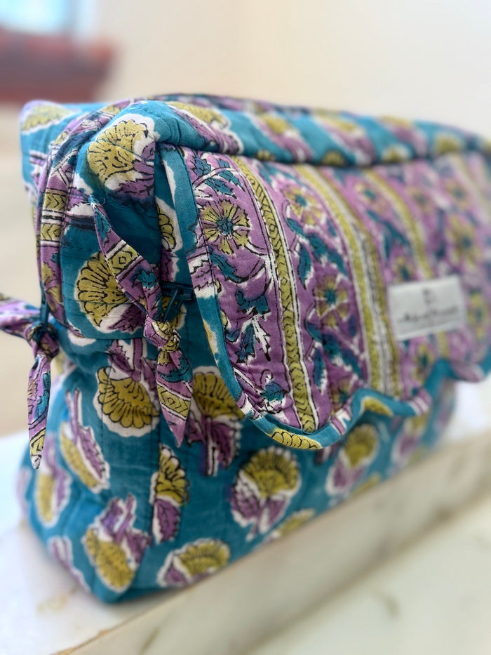 side view of scalloped toiletry and cosmetics bags