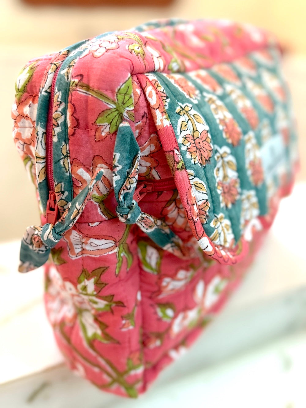 Close-up of hand block printed cotton cosmetic bag showing carved woodblock pattern detail