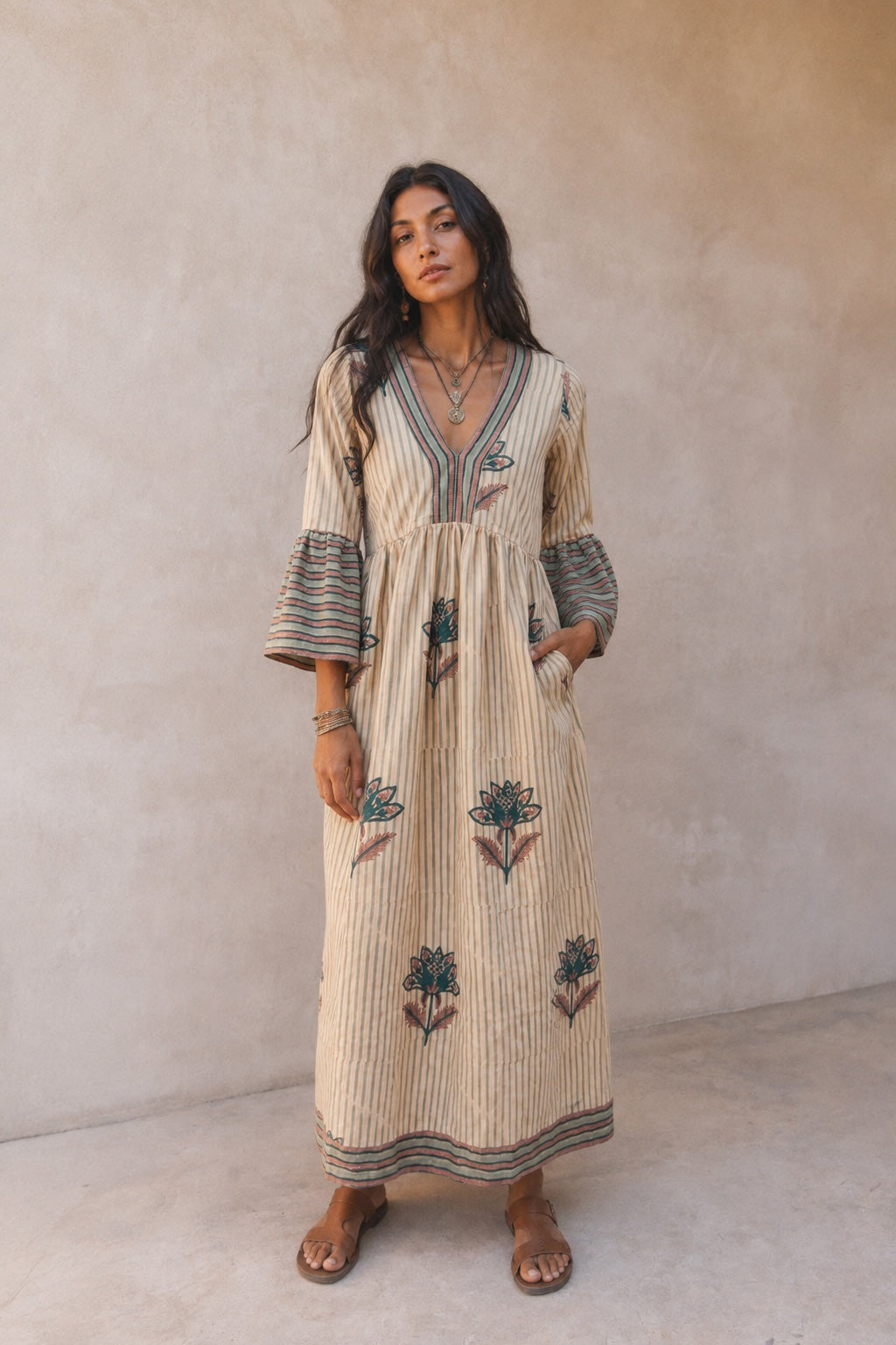 cream colored midi dress with blue flowers and striped borders
