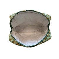 Waterproof plastic-lined interior of quilted block print makup travel bag