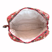 Waterproof plastic-lined interior of quilted block print cosmetic travel bag