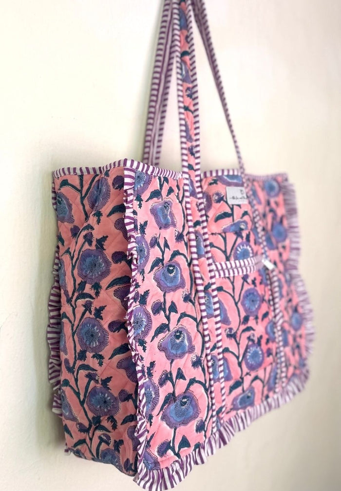 side view of pink bag with blue block printed flowers