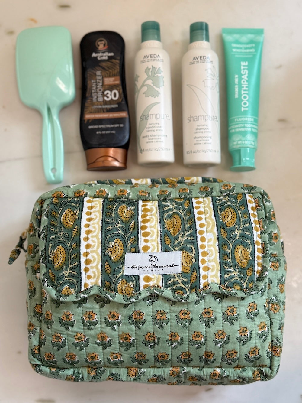 large size travel bag with 4 large size bottles and a hairbrush