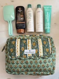 large size travel bag with 4 large size bottles and a hairbrush